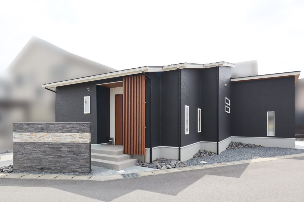 外は黒をメインに白と木目柄を差し色にした、重厚感ありつつおしゃれな外観の平屋です。土地形状に合わせて設計された間取りとなっています。